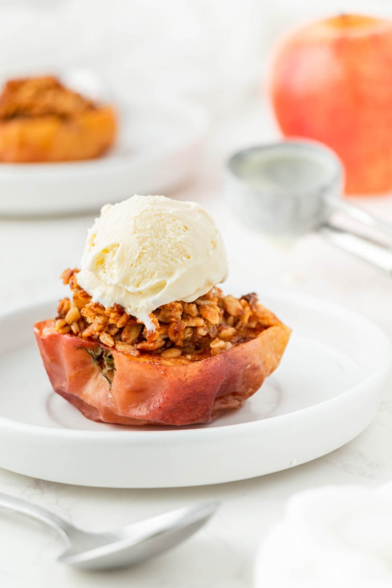 close up of an air fryer baked apple with a scoop of vanilla ice cream on top