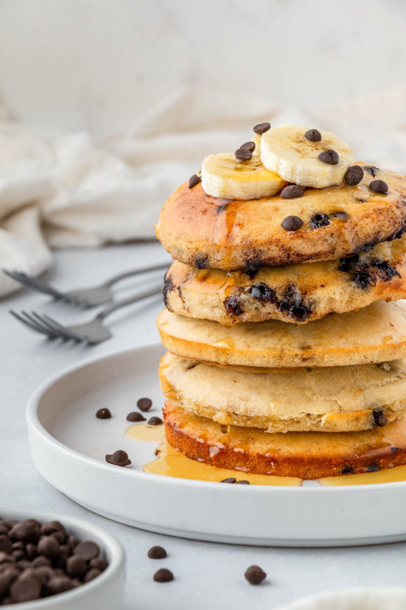 a stack of air fryer pancakes with bananas and chocolate chips on top