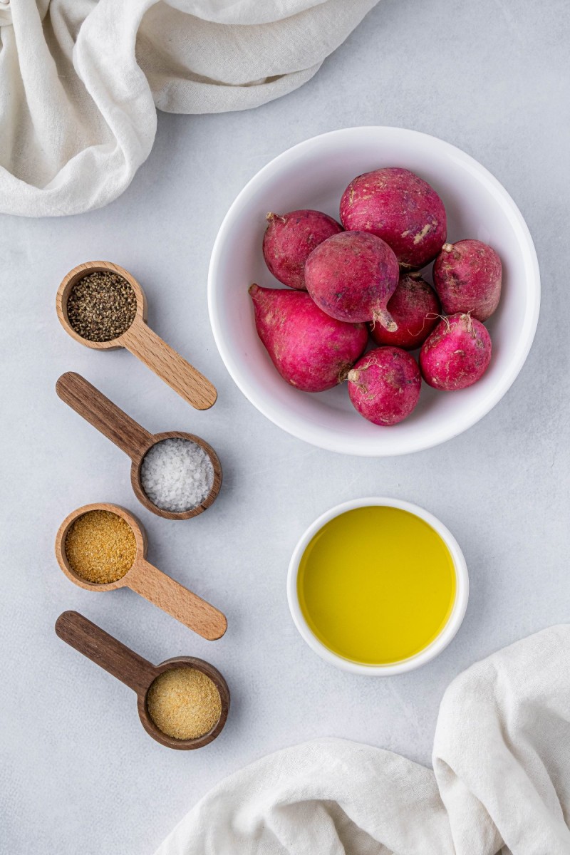 radishes, olive oil, and spices in small ingredient bowls