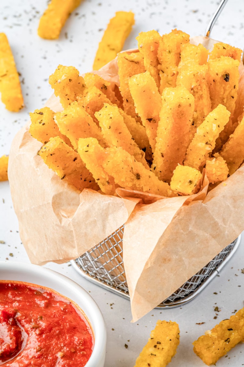 air fryer polenta fries in a small fries basket