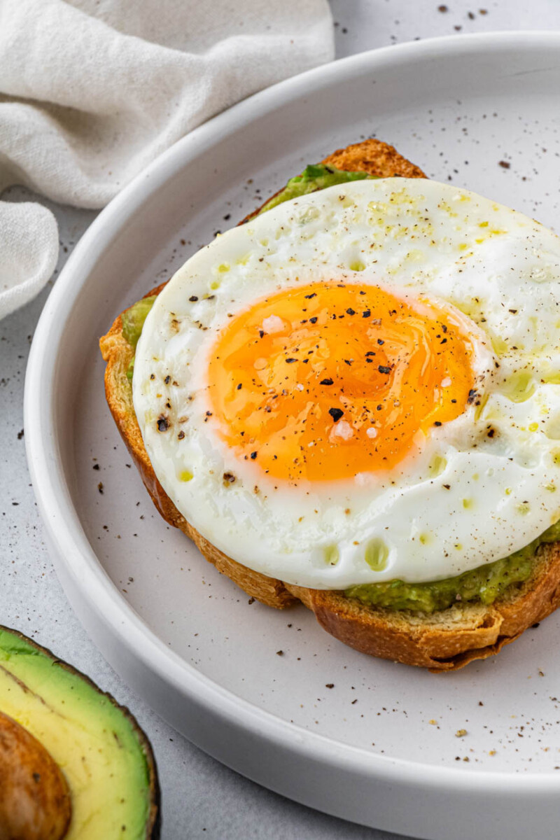 air fryer fried eggs on a piece of avocado toast