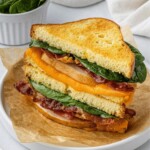 air fryer turkey sandwich halves stacked on top of each other on a white plate