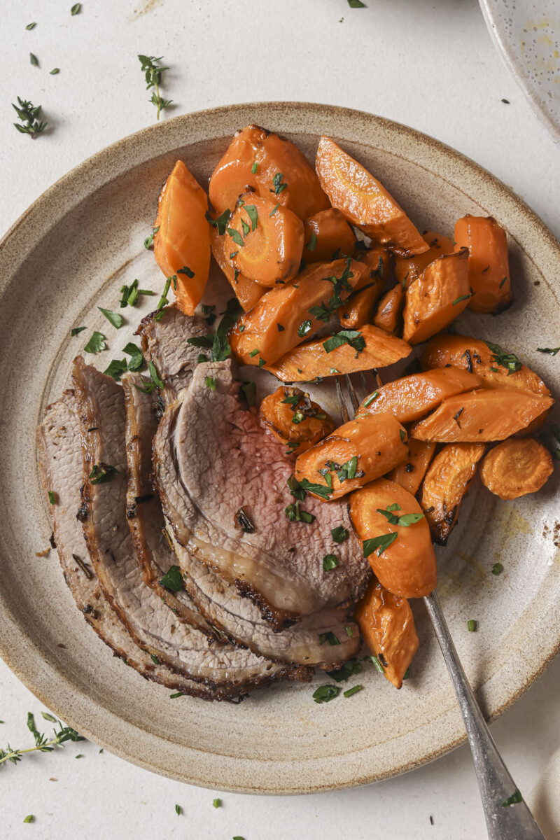 air fryer brisket sliced on a plate with carrots