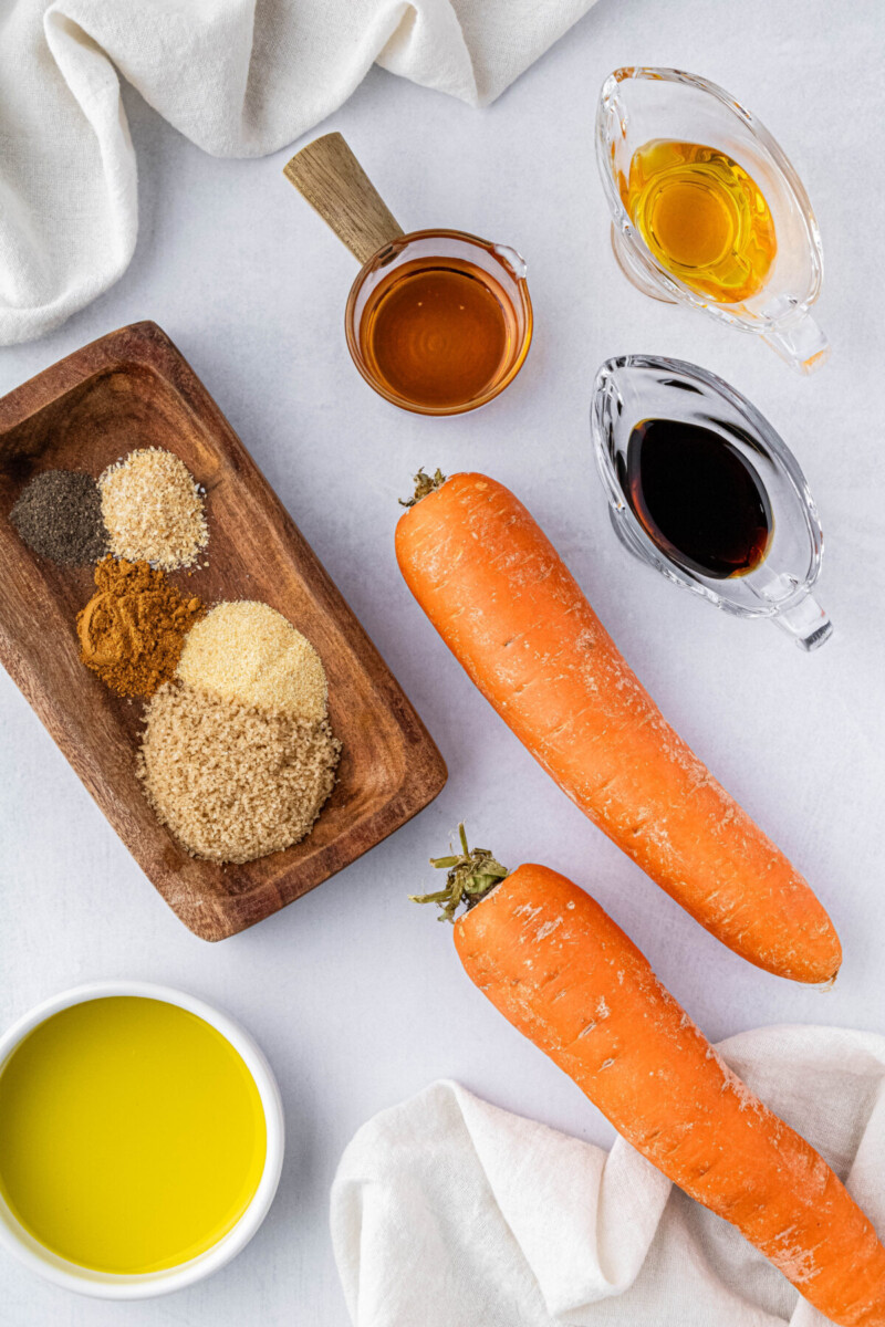 two large carrots and spices, maple syrup and olive oil in small ingredient bowls