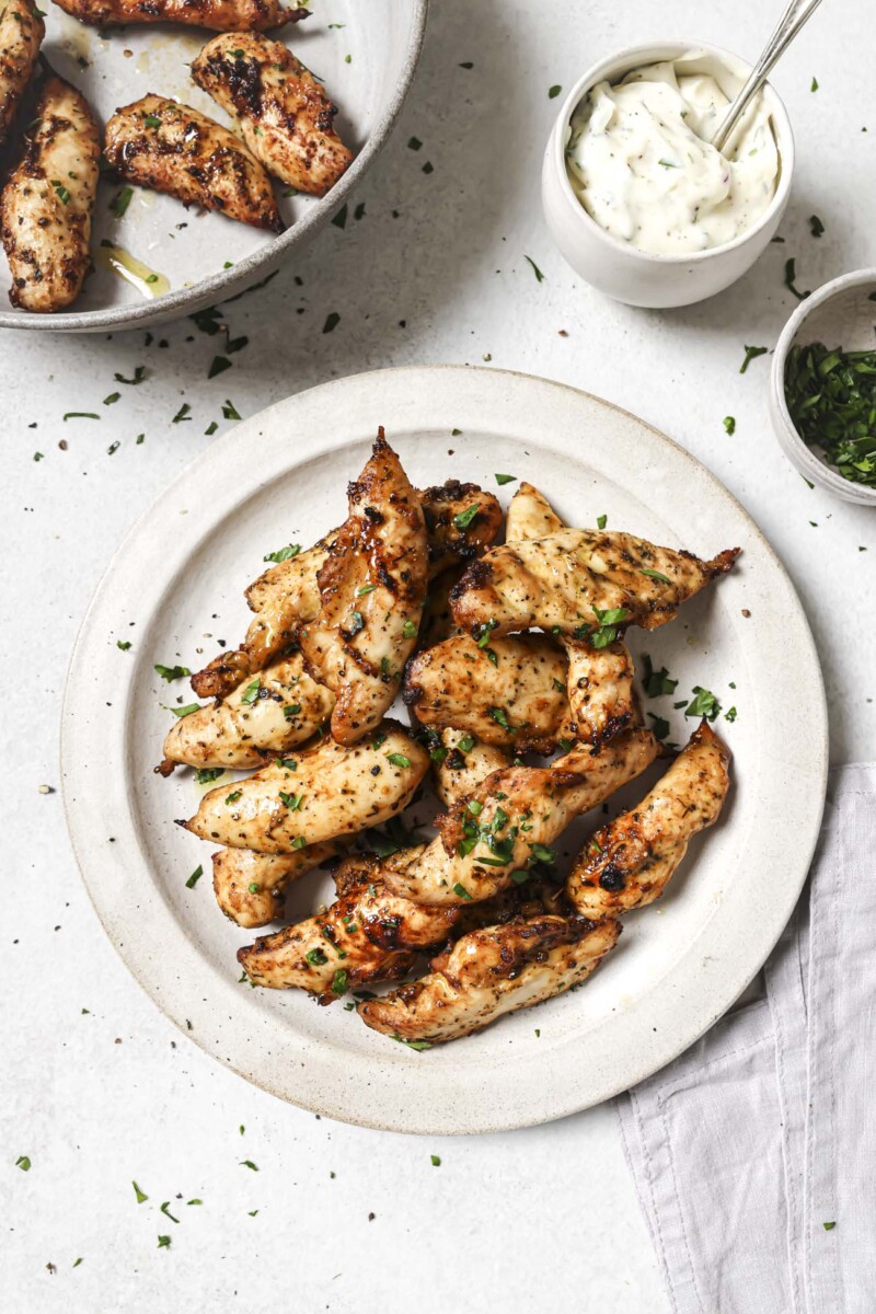 Overhead view of a plate of air fryer chicken tenders.