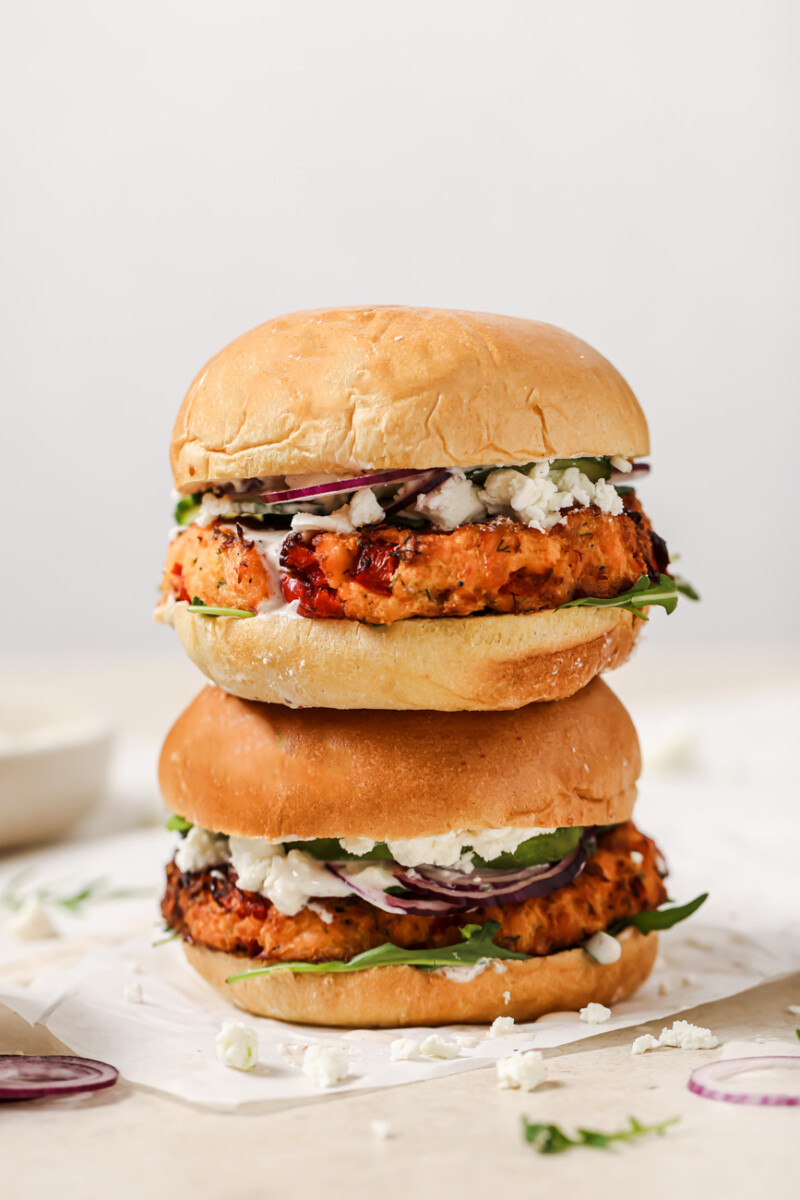 Two air fryer salmon burgers stacked on top of each other.