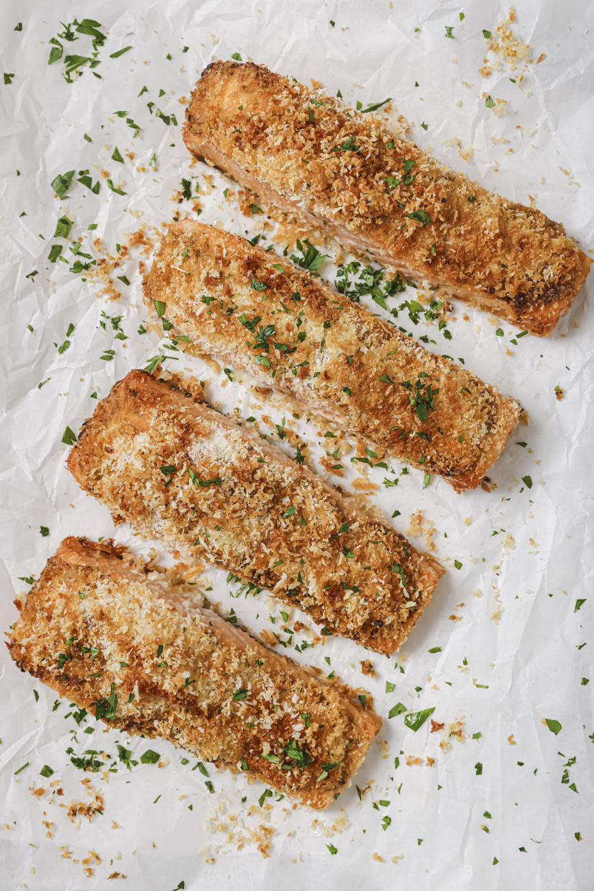 Overhead view of 4 pieces of golden brown panko crusted salmon.