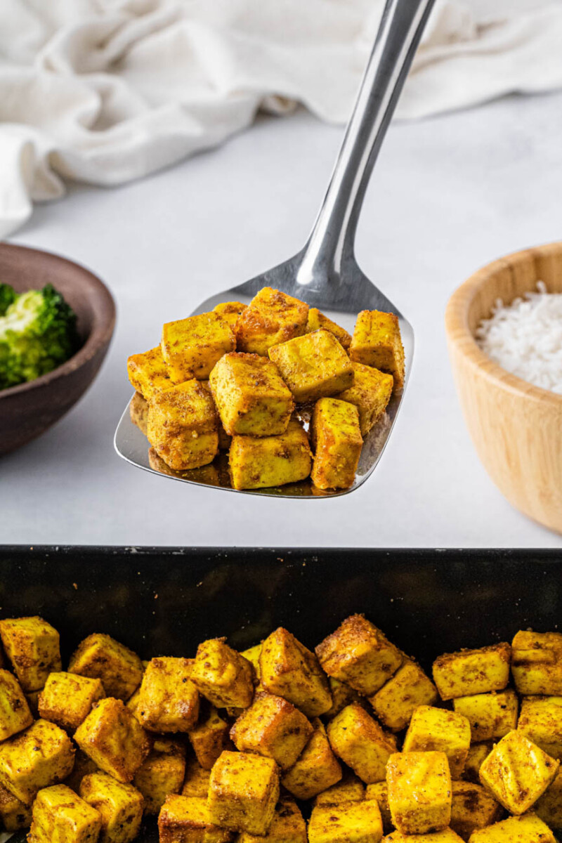 a metal spatula serving air fried tofu