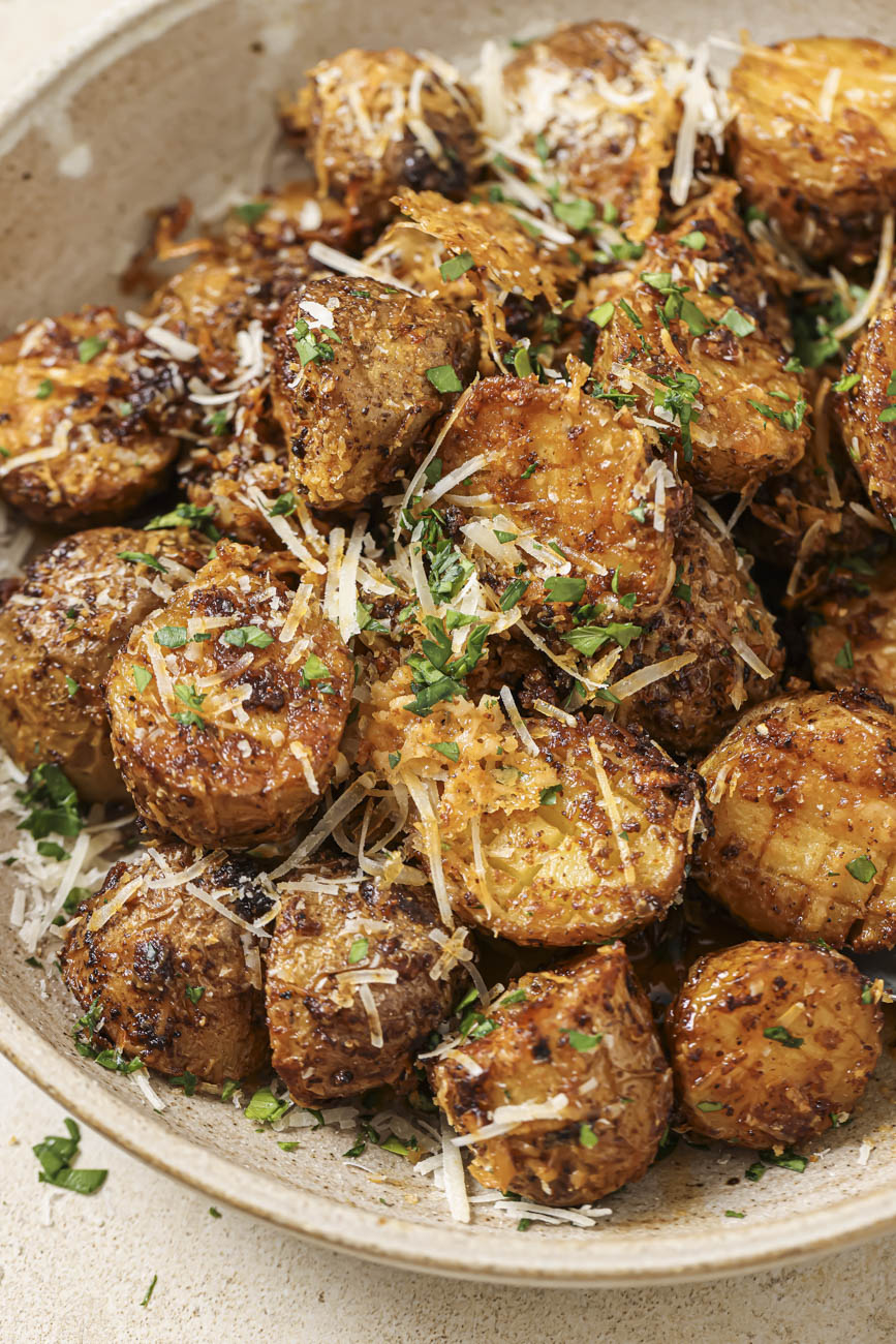 Close up of a bowl of air fryer parmesan potatoes.