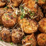 Close up of a bowl of air fryer parmesan potatoes.