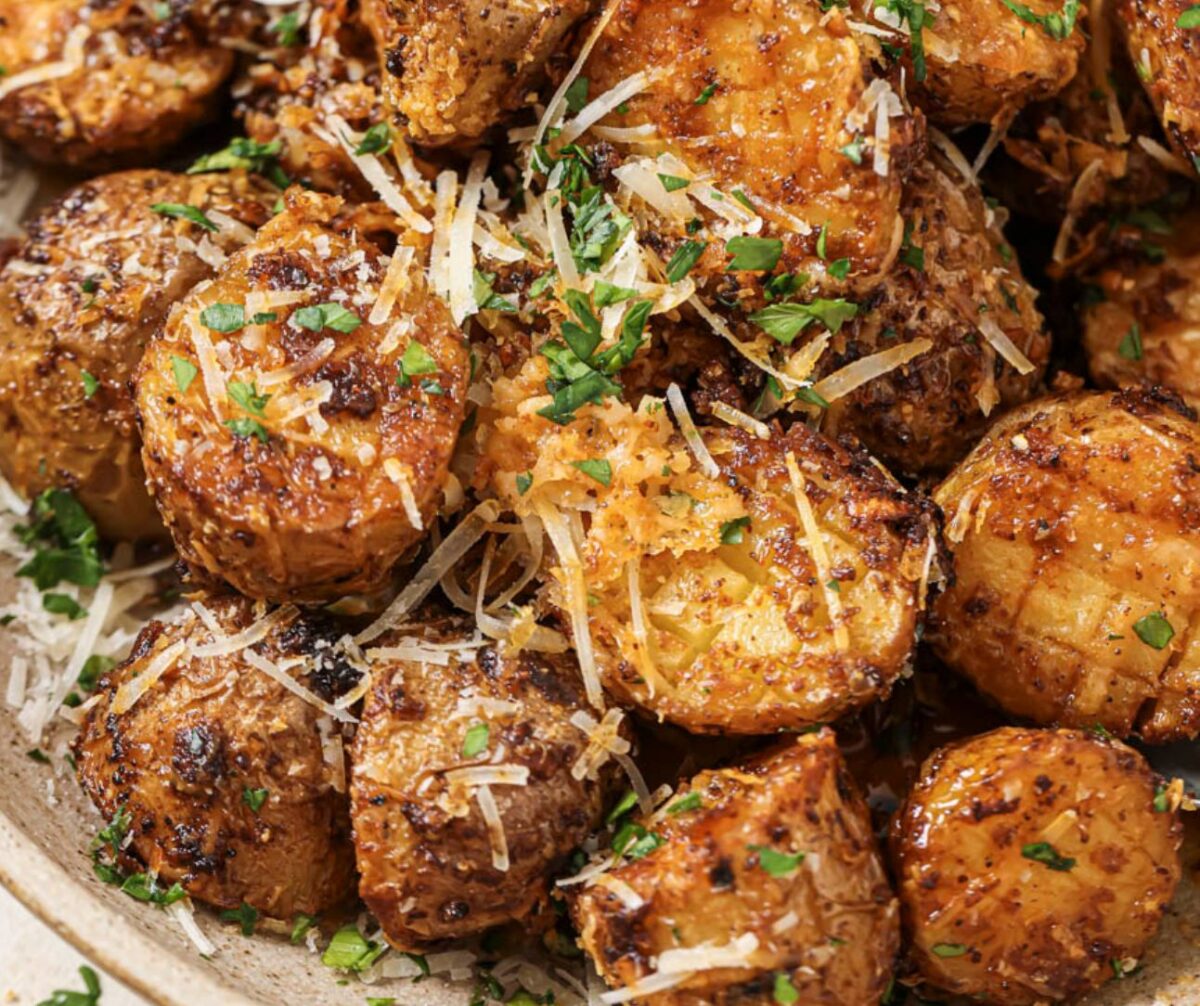 Close up of a bowl of air fryer parmesan potatoes.