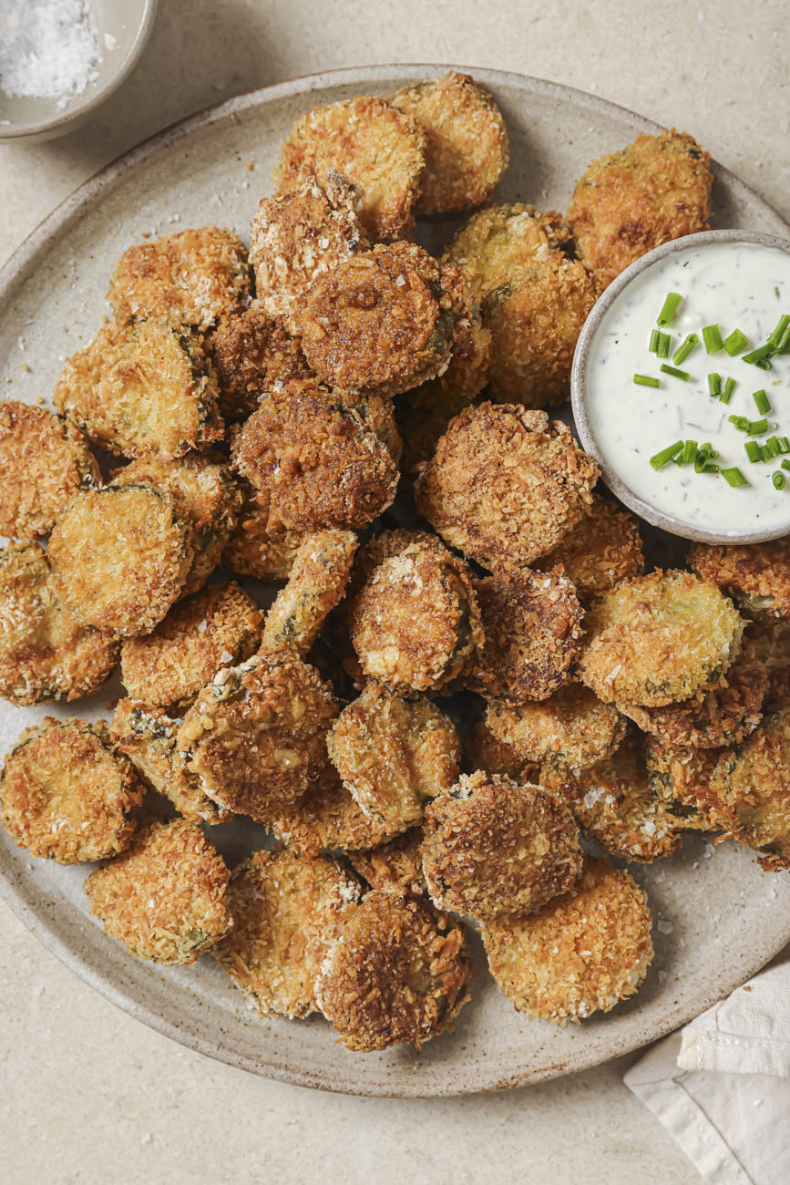 Top down view of a plate of air fryer fried pickles and ranch dressing.