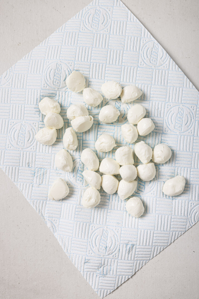 Drying mozzarella balls on a paper towel.