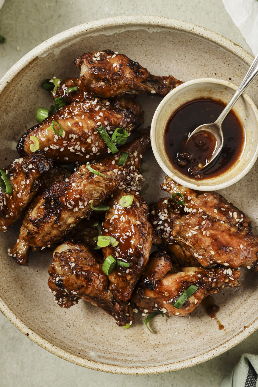 Top down view of a bowl of air fryer asian chicken wings.