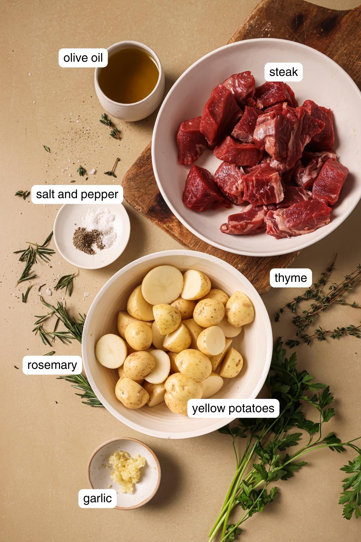 Labeled ingredients for air fryer steak bites with potatoes.