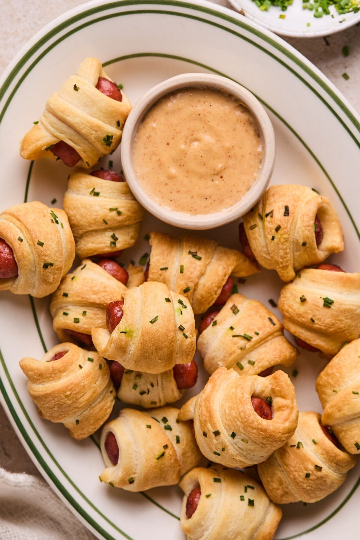 A platter of air fryer pigs in a blanket with queso.